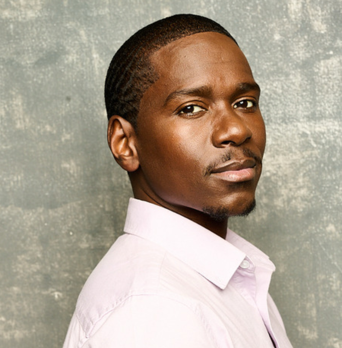 Maurice Mack, headshot in a pink shirt