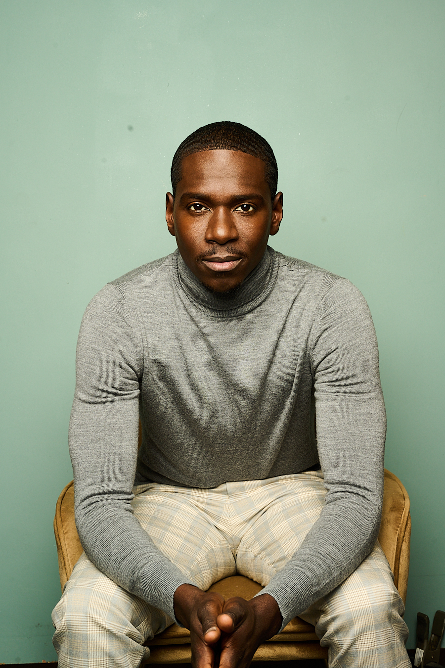 Maurice Mack seated in a grey sweater