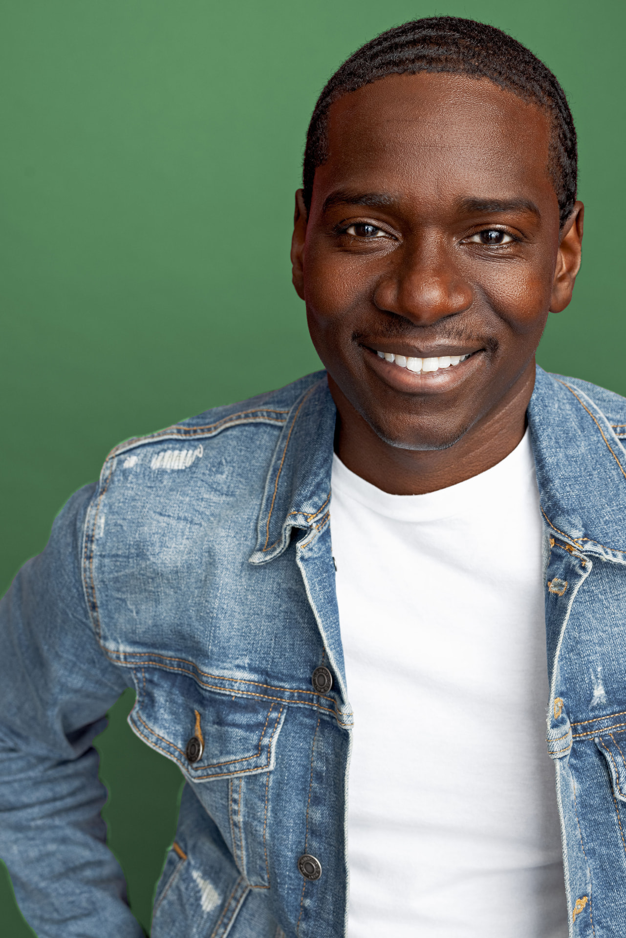 Maurice Mack smiling in a denim jacket
